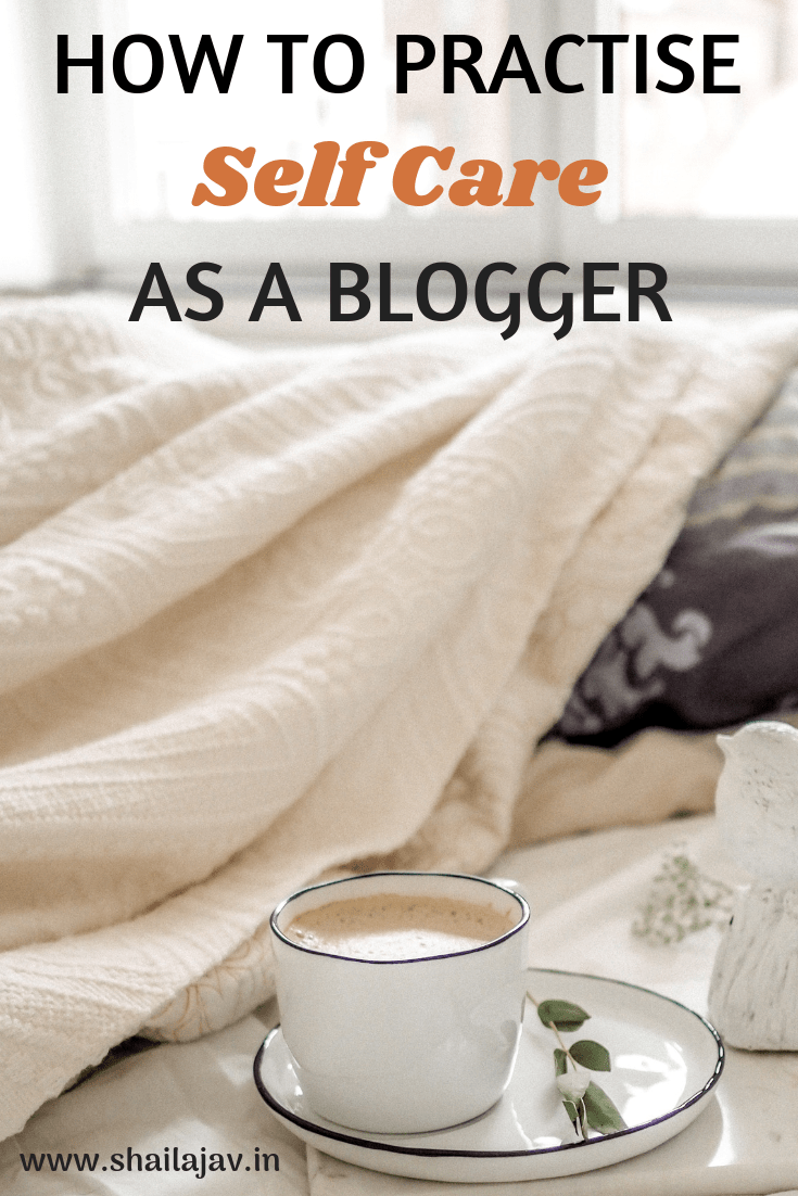 A cup of coffee set against a crumpled sheet on a bed, indicating Self Care as a Blogger- Making time for life.